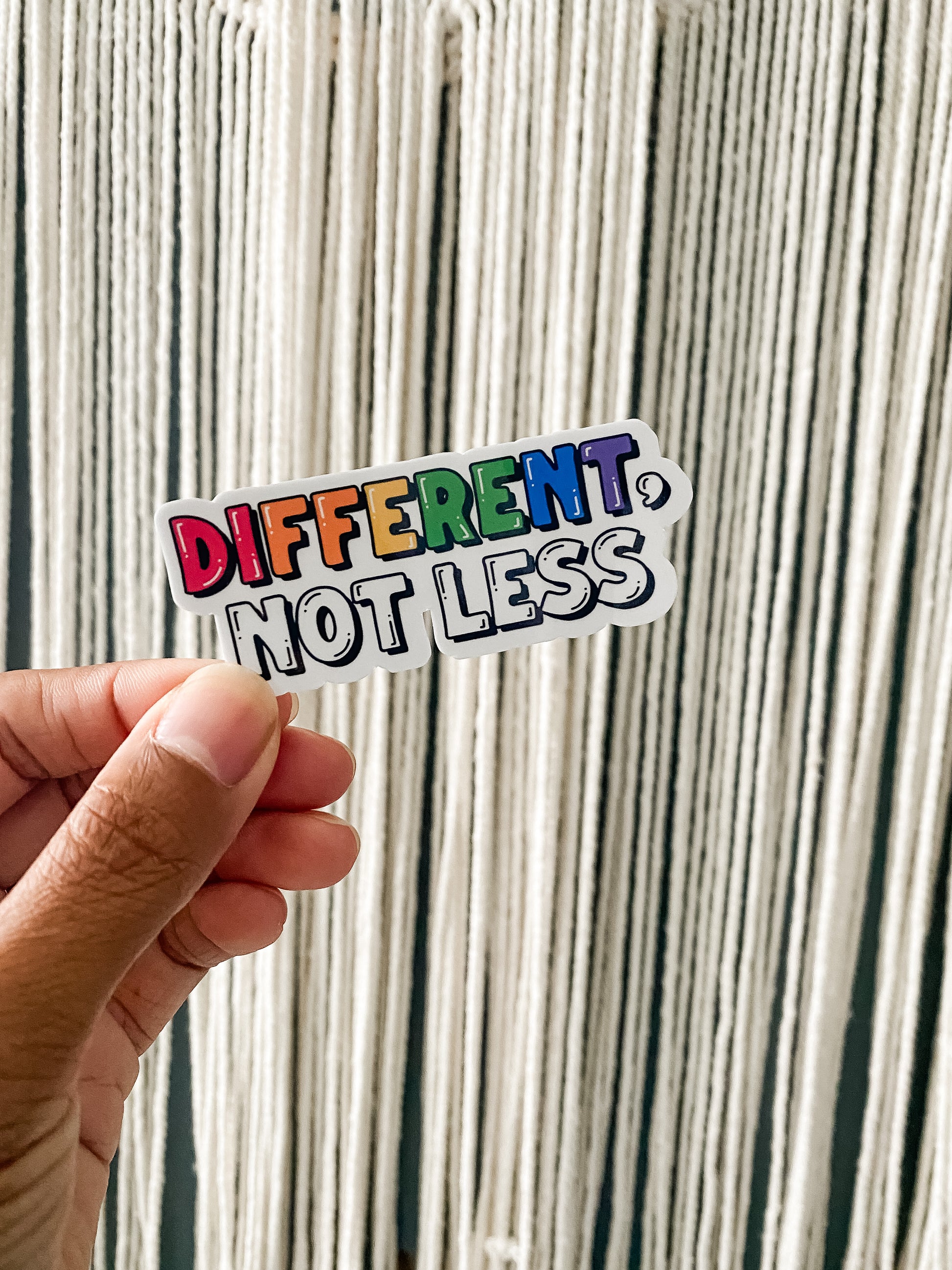 "Different, Not Less" sticker. DIFFERENT colored with rainbow order.
